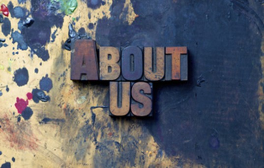"About us" in carved block letters
