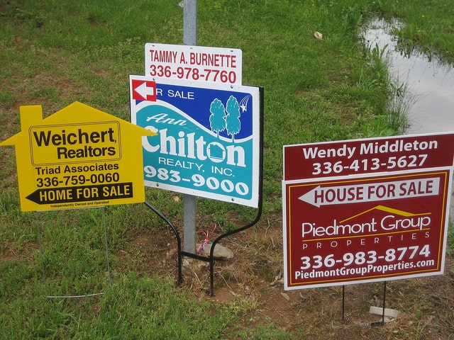 three for-sale signs