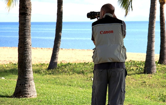 A man shoots photos on the beach