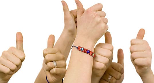 Group of hands giving thumbs up.