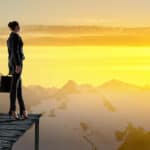 woman leader looking over a range of mountains.