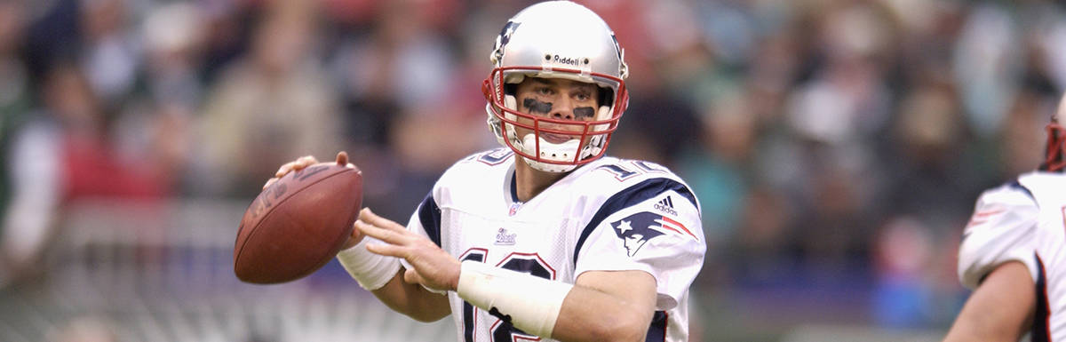 Tom Brady, in his Patriots uniform, preparing to throw the football
