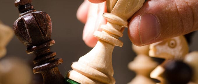 close-up of wooden chess piece going on offense