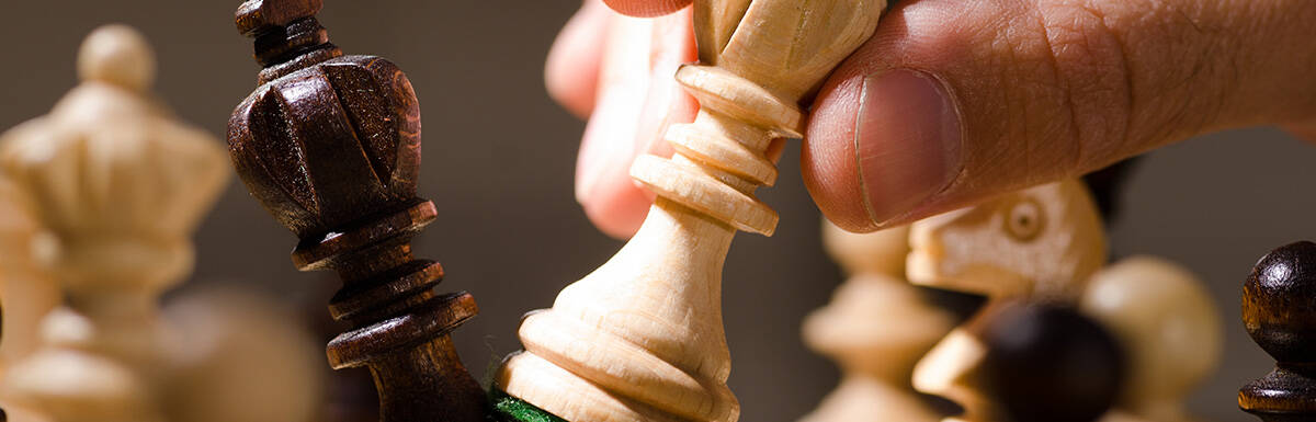 close-up of wooden chess piece going on offense