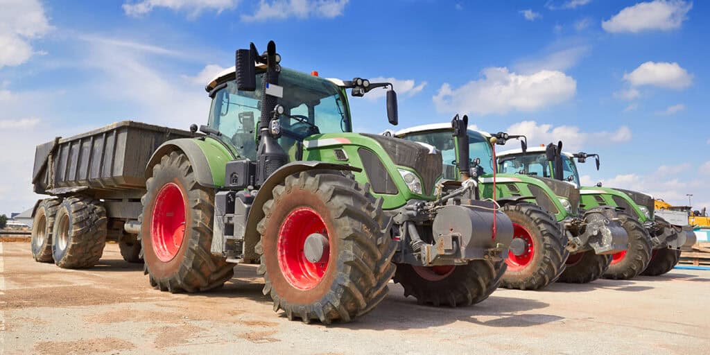 Green tractors parked side by side